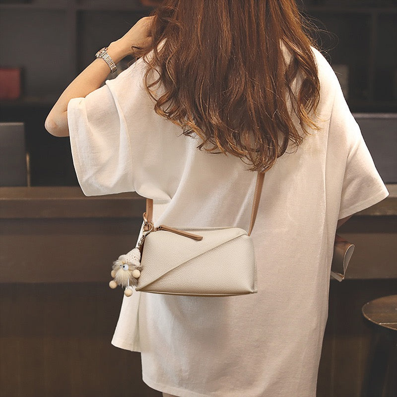 Elegant Geometric Genuine Leather Crossbody Bag with Plush Charm